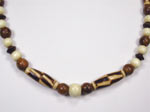 brown and beige wood necklace with burnt wood rice