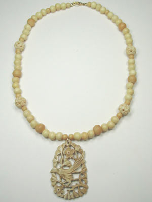 handmade bone necklace with carved pendant